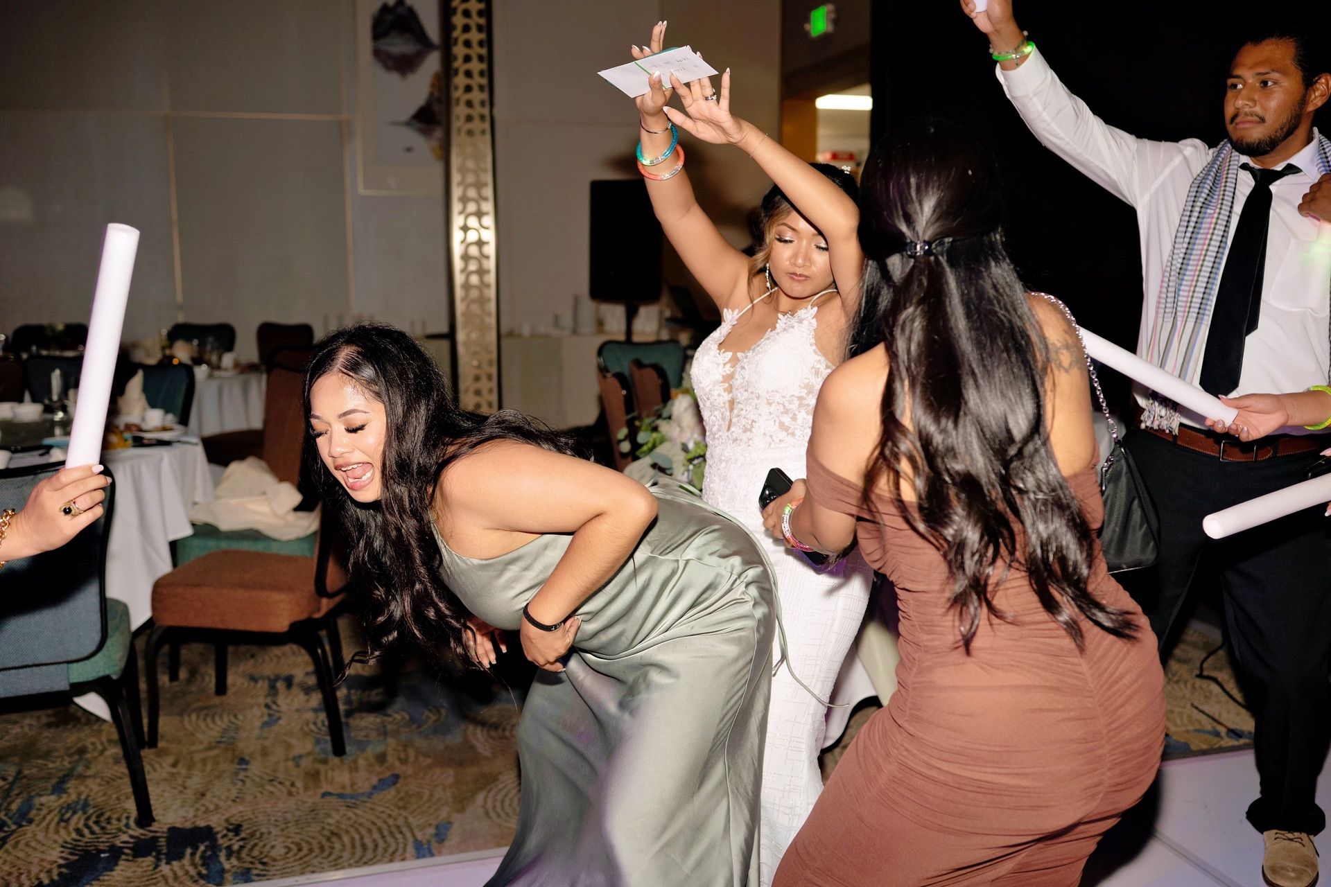 Bride and bridesmaid dancing during the reception